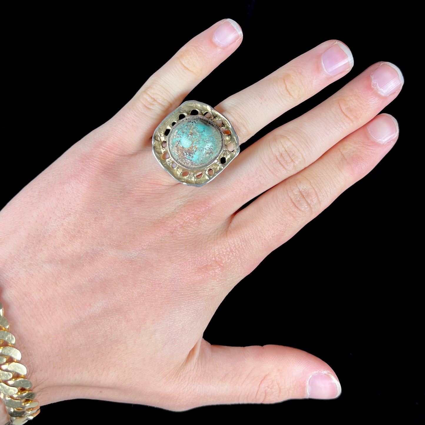 A unisex sterling silver ring with a gold wash, set with a natural, unstabilized Valley Blue turquoise stone.