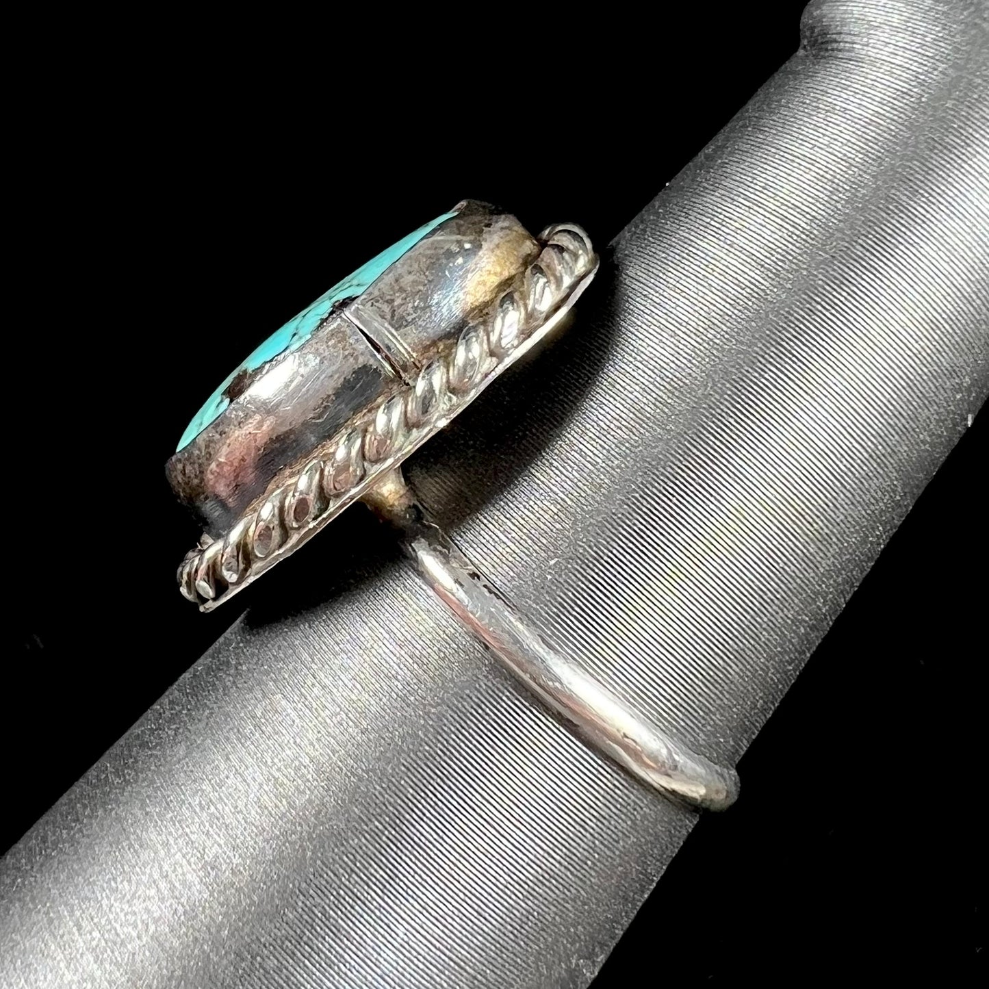 A handmade ladies' turquoise solitaire ring. The ring has a rope bezel design.