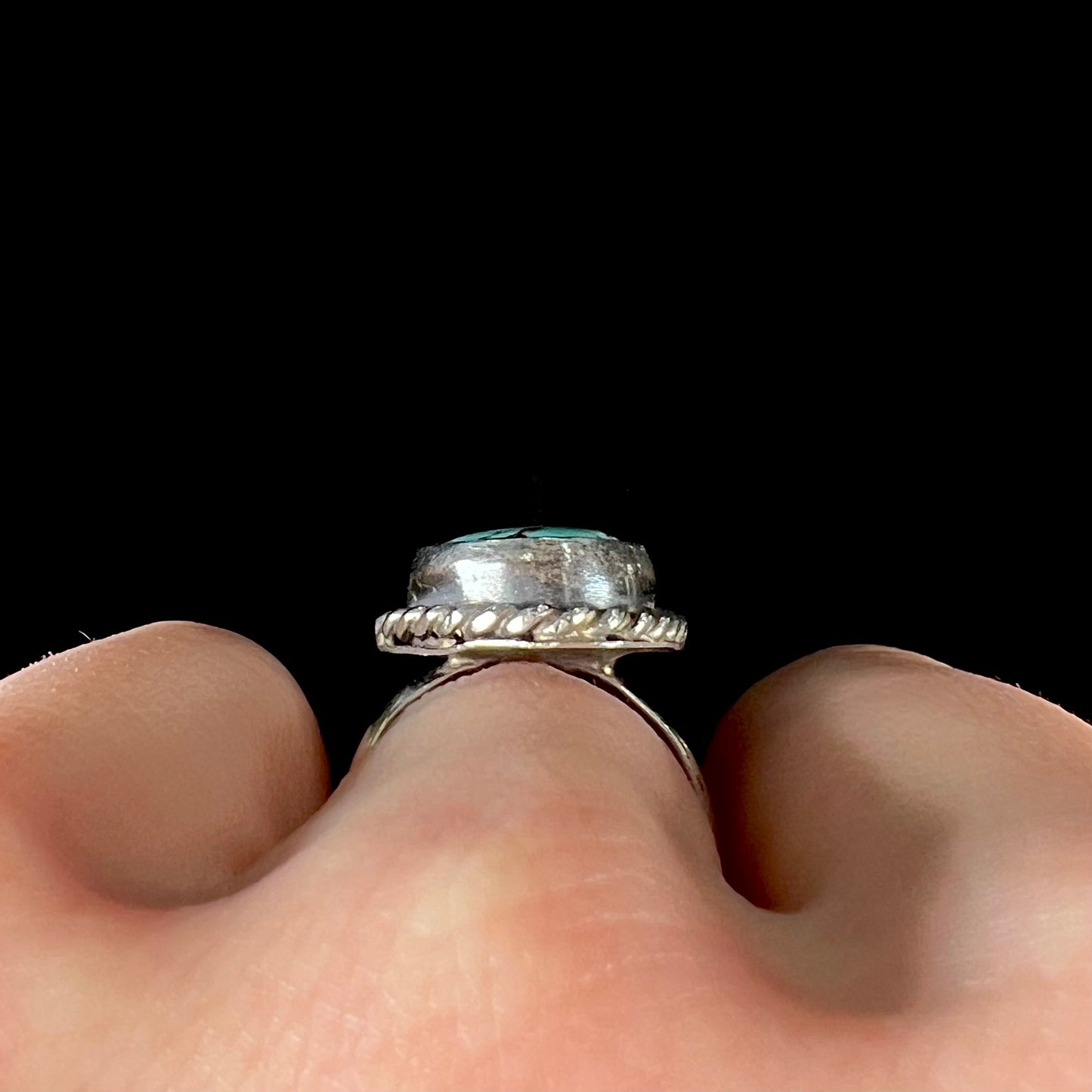 A handmade ladies' turquoise solitaire ring. The ring has a rope bezel design.
