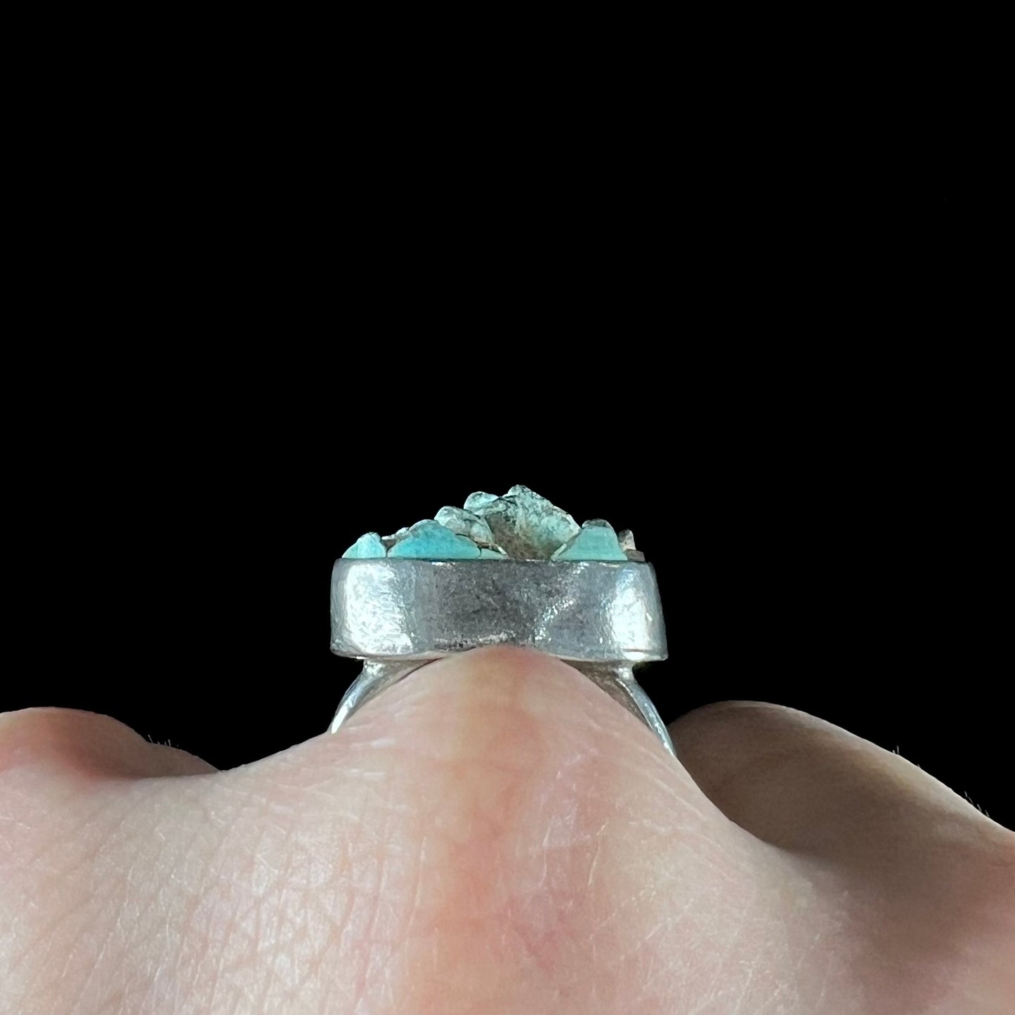 A handmade unisex sterling silver solitaire ring set with a rough, unpolished piece of turquoise stone.