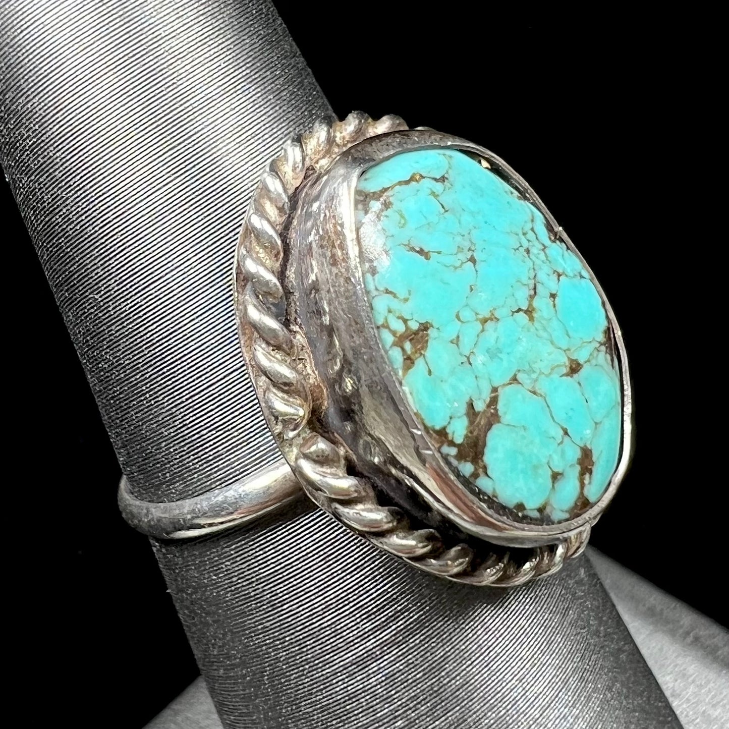 A handmade ladies' turquoise solitaire ring. The ring has a rope bezel design.
