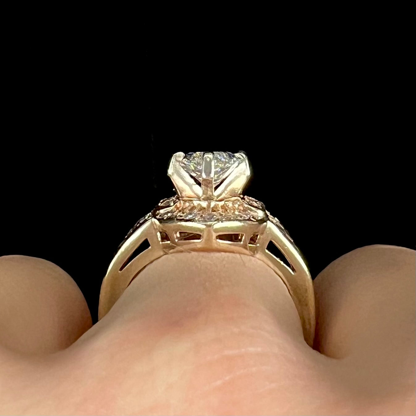 A ladies' yellow gold engagement ring set with a 1.54ct marquise cut natural diamond with round diamond accents.