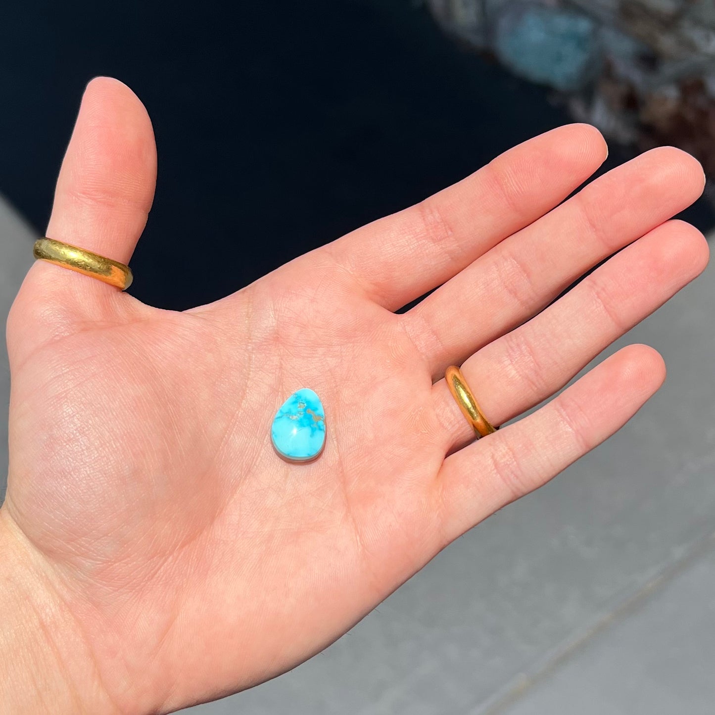 A loose, drop shaped, cabochon cut Sleeping Beauty turquoise stone.