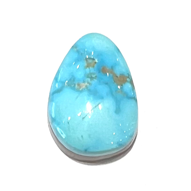 A loose, drop shaped, cabochon cut Sleeping Beauty turquoise stone.