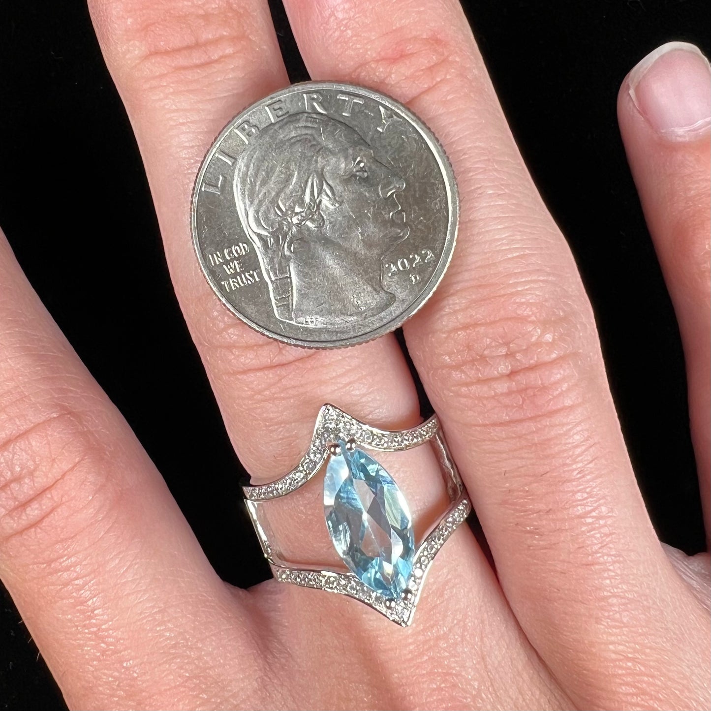 A ladies' marquise cut blue topaz and cubic zirconia accented ring cast in sterling silver.