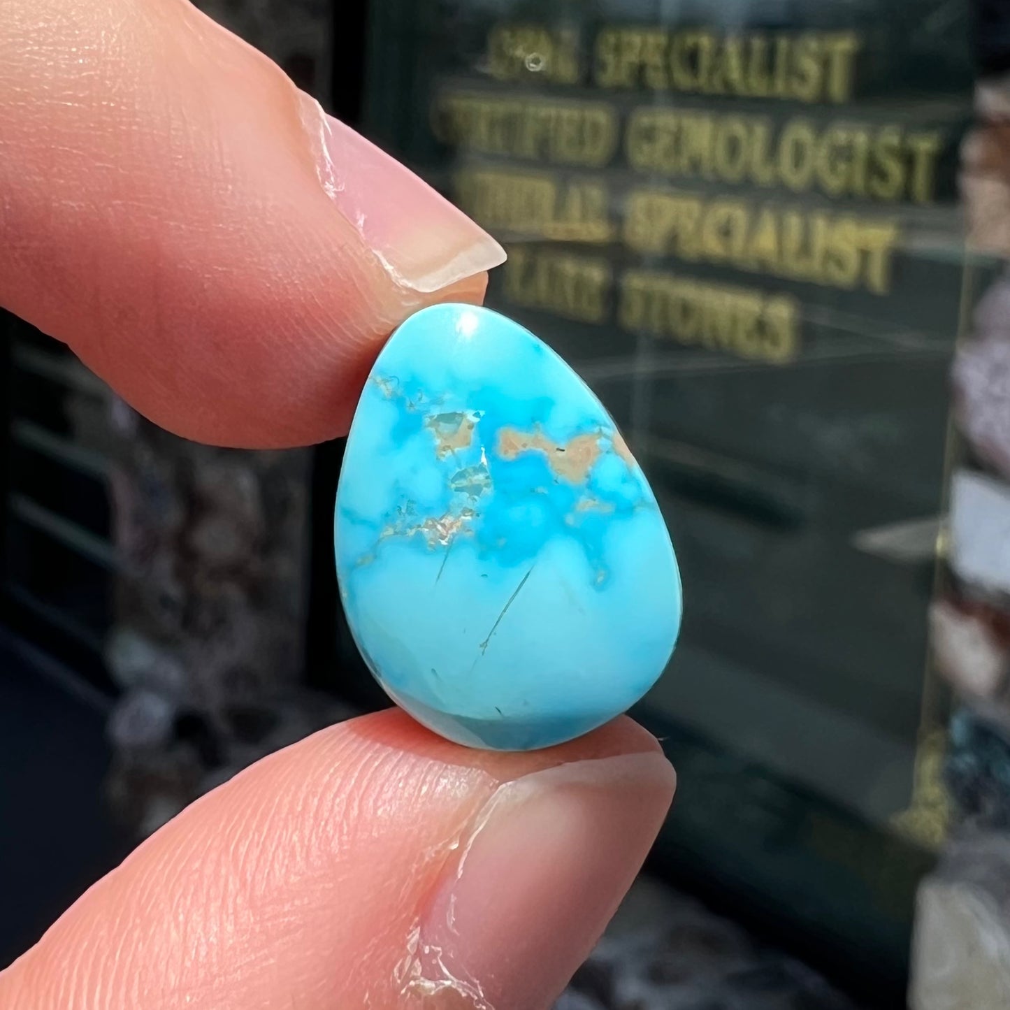 A loose, drop shaped, cabochon cut Sleeping Beauty turquoise stone.