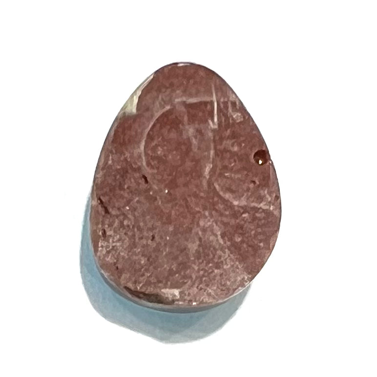 A loose, drop shaped, cabochon cut Sleeping Beauty turquoise stone.