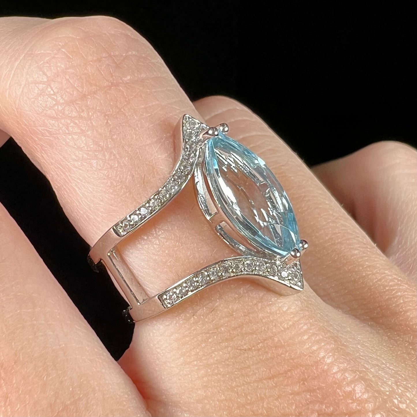 A ladies' marquise cut blue topaz and cubic zirconia accented ring cast in sterling silver.