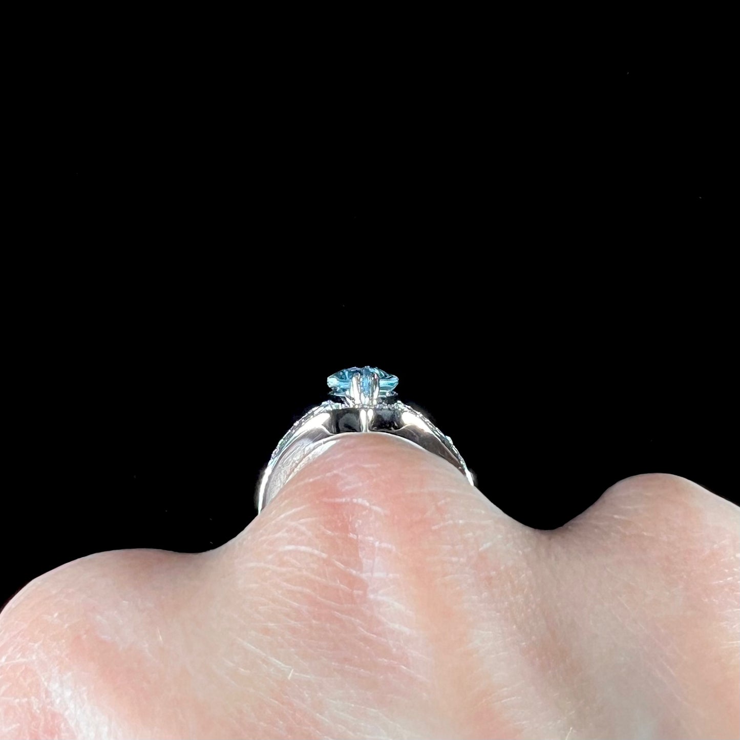 A ladies' marquise cut blue topaz and cubic zirconia accented ring cast in sterling silver.