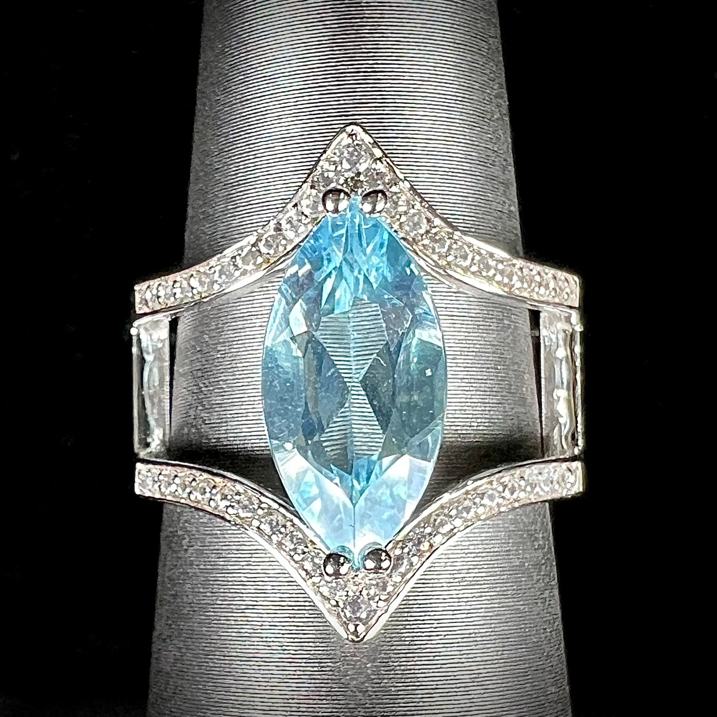A ladies' marquise cut blue topaz and cubic zirconia accented ring cast in sterling silver.