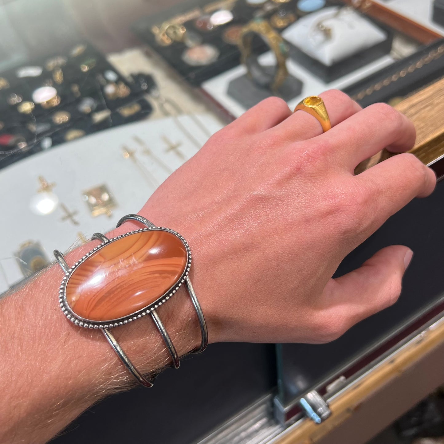 A sterling silver cuff bracelet set with a oval cabochon cut brown Biggs picture jasper stone.