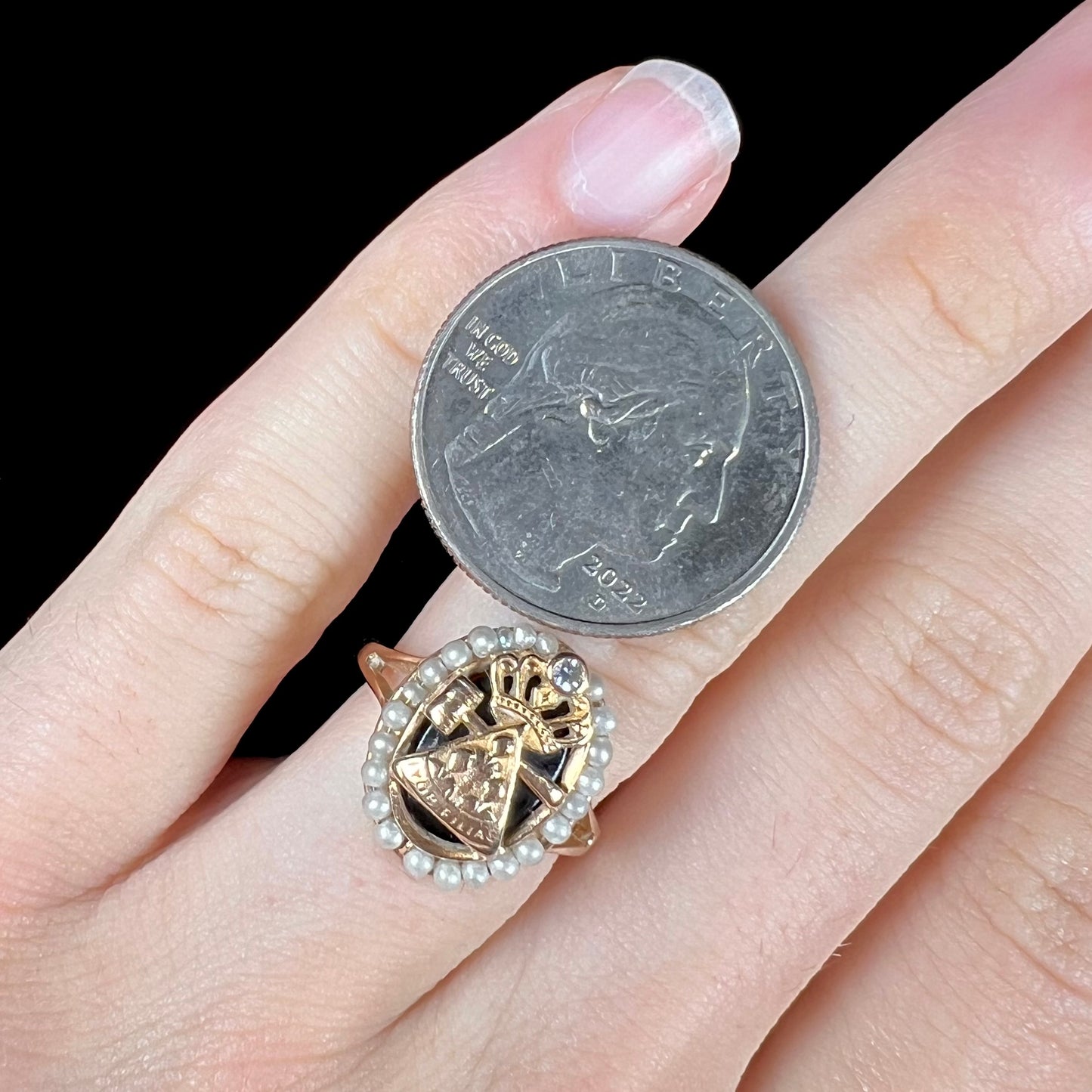 A ladies' Job's Daughters youth organization ring cast in 14 karat gold, set with a diamond and string of pearls.