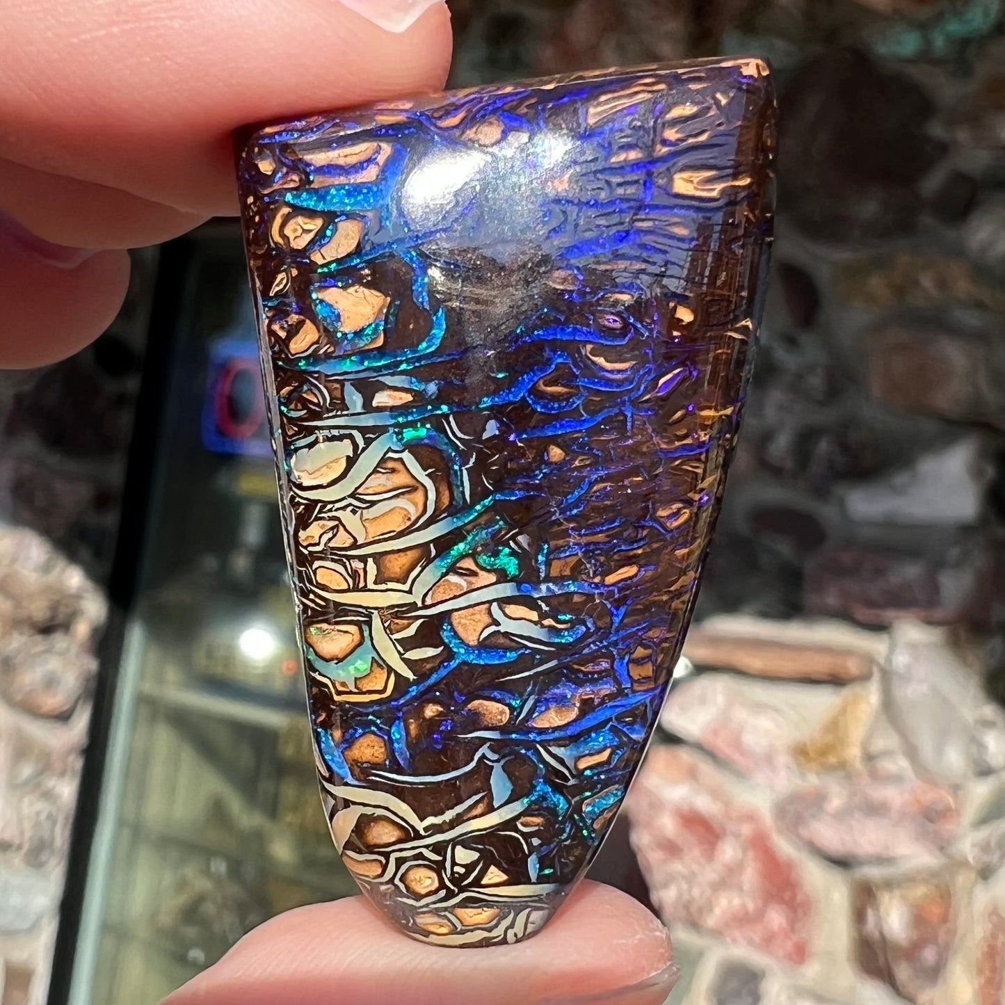 A loose boulder opal stone from Koroit, Australia. The opal has a blue and purple pattern.