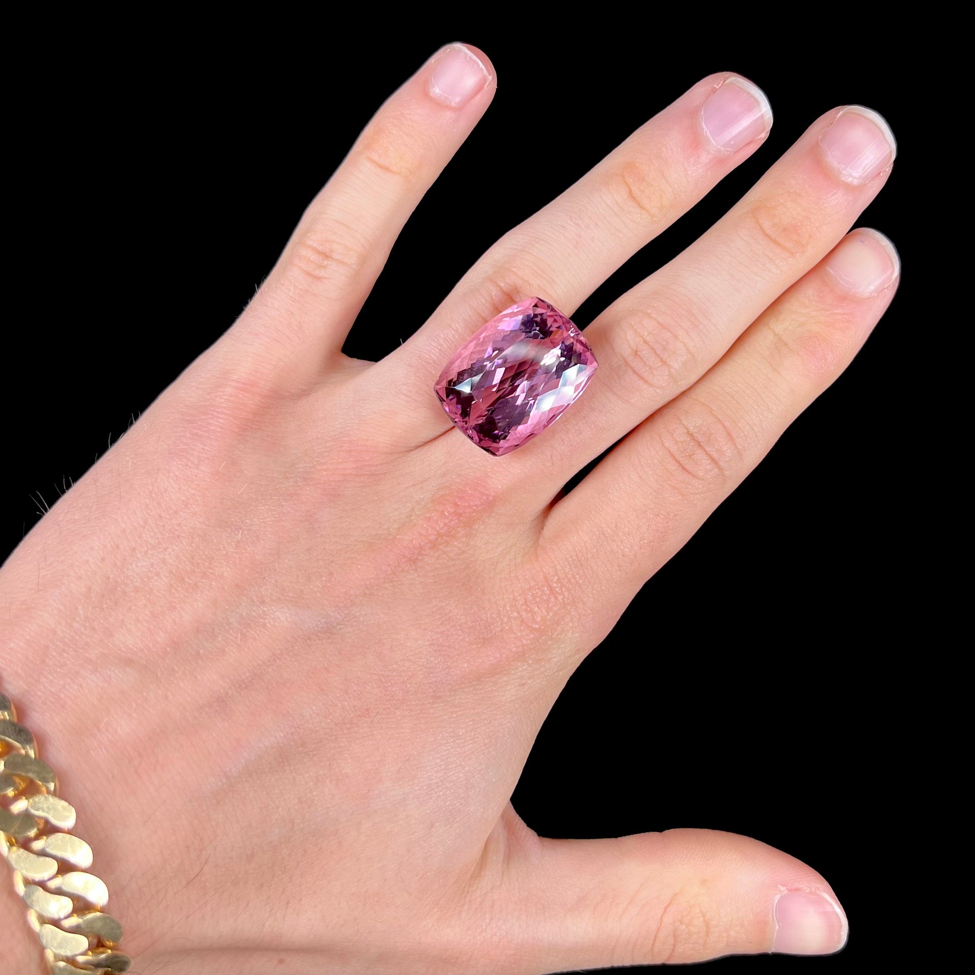 A modified cushion cut Afghanistan kunzite gemstone.  The stone is a purplish pink color and weighs 49.30 carats.