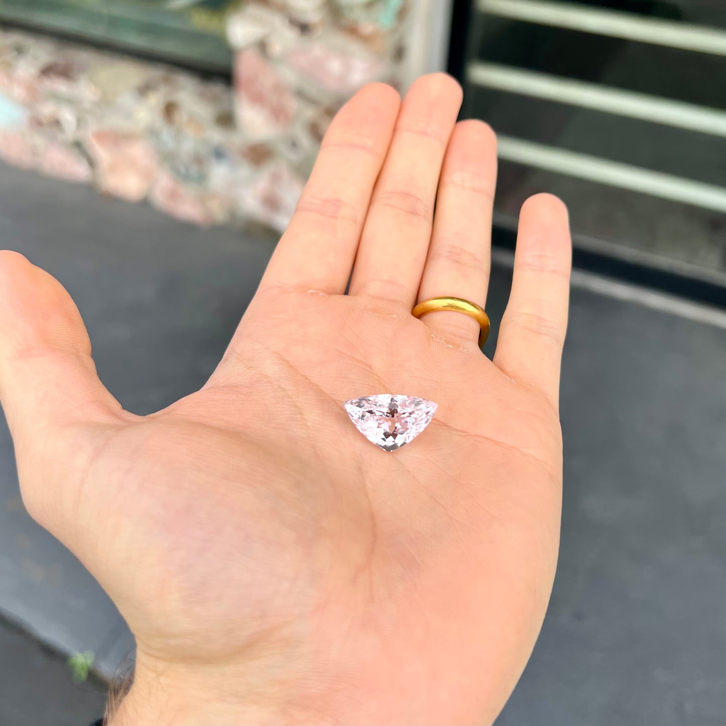 A loose, modified trillion cut kunzite gemstone. The stone weighs 14.81 carats.