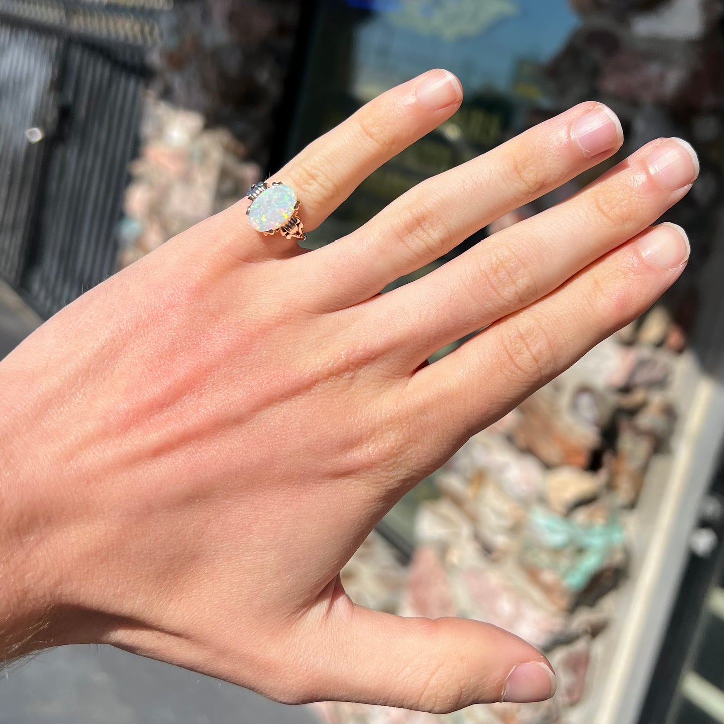 A ladies' Art Deco style natural opal solitaire ring in yellow gold. The opal is oval cut.