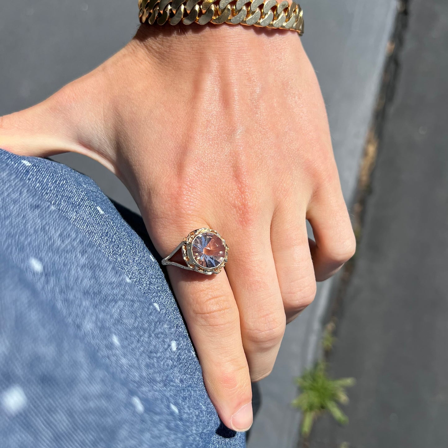 A ladies' yellow gold solitaire ring bezel set with a modified bud cut morganite gemstone.