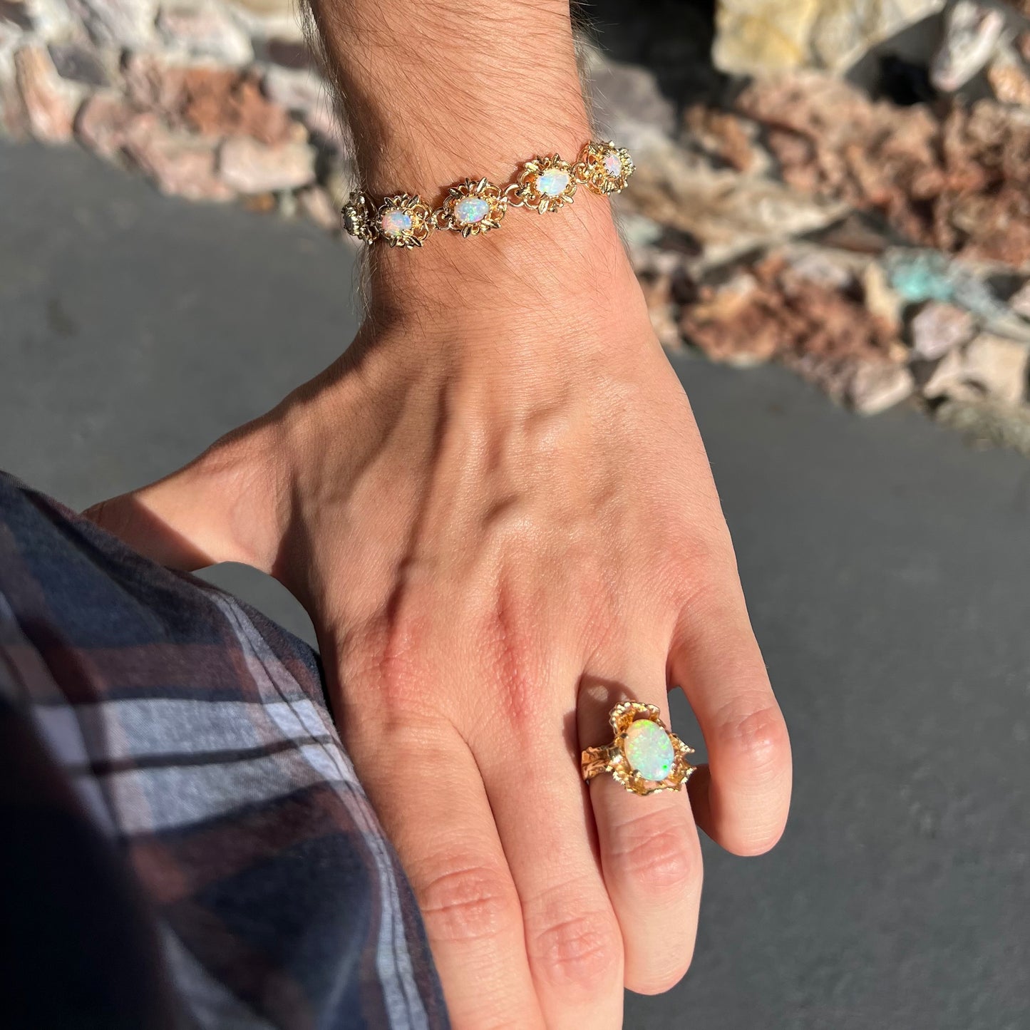 A ladies' yellow gold bracelet set with natural, oval cabochon cut white crystal opals.