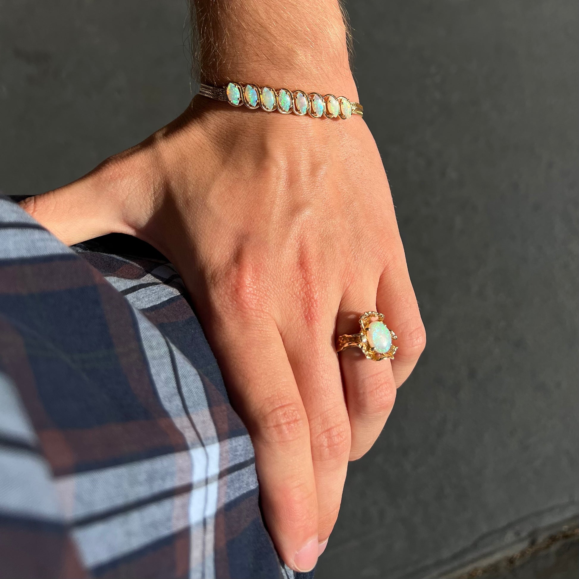 A ladies' yellow gold bracelet prong set with eight natural, marquise cabochon cut opals.