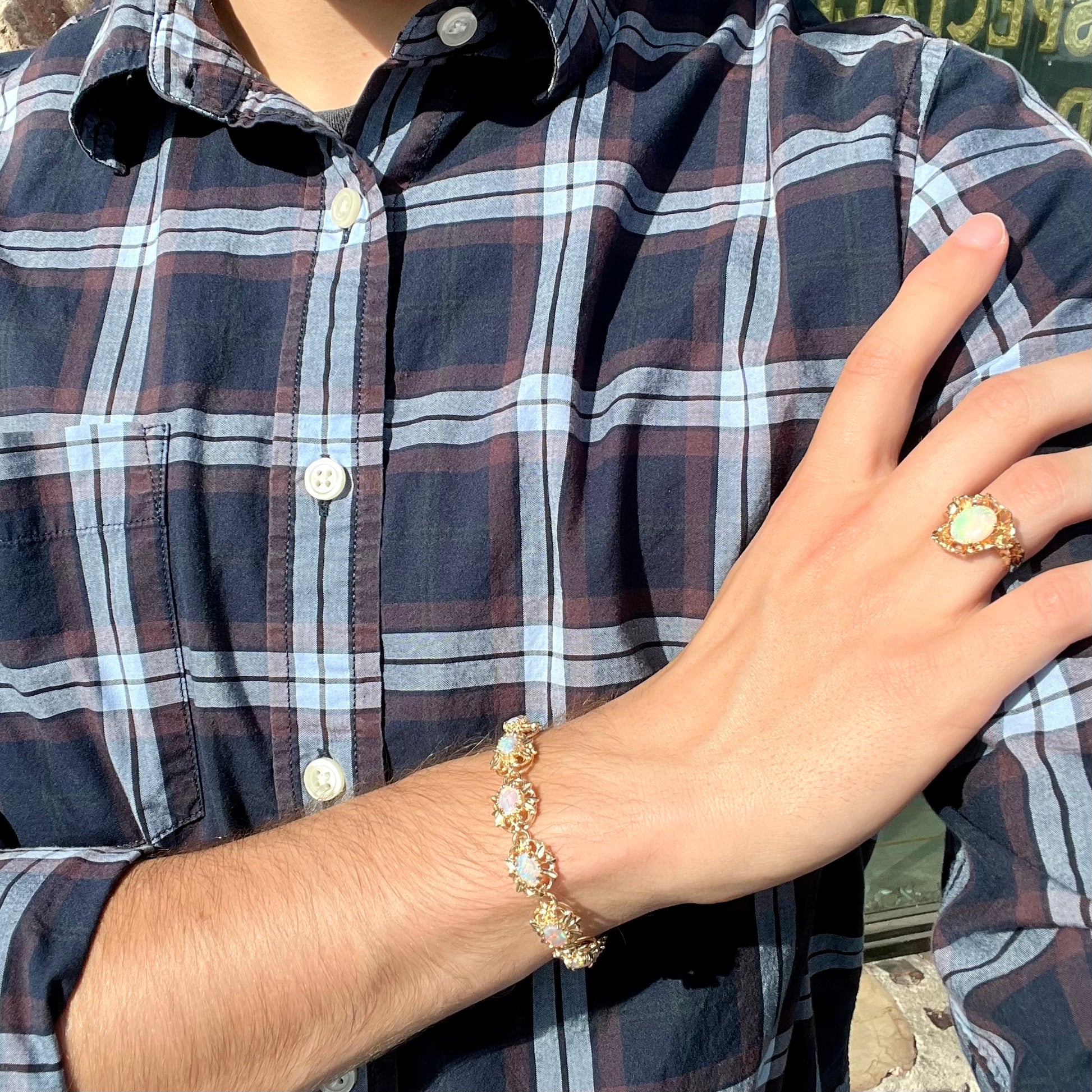 A ladies' yellow gold bracelet set with natural, oval cabochon cut white crystal opals.