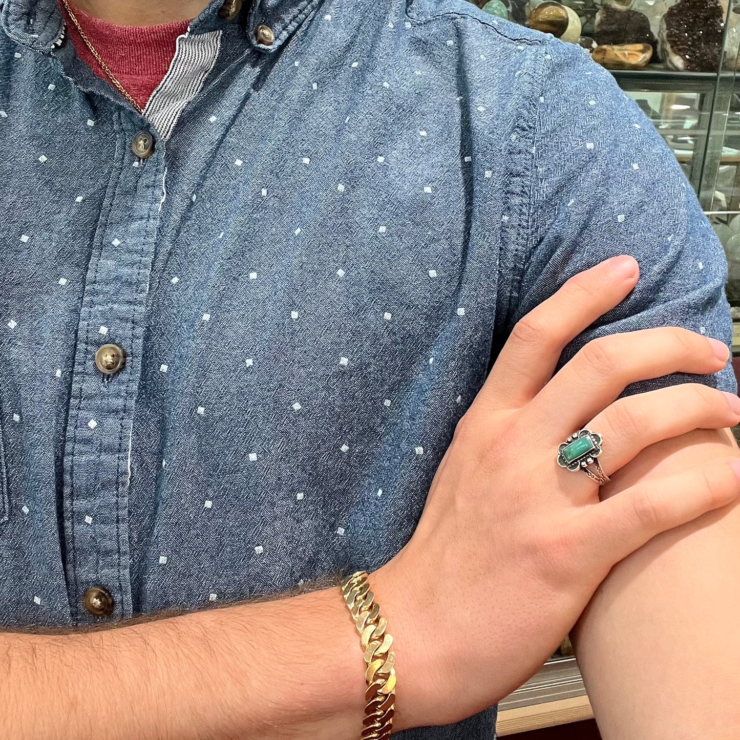 A ladies' silver ring stamped with Southwest style designs and set with a rectangular cabochon cut Royston turquoise stone.