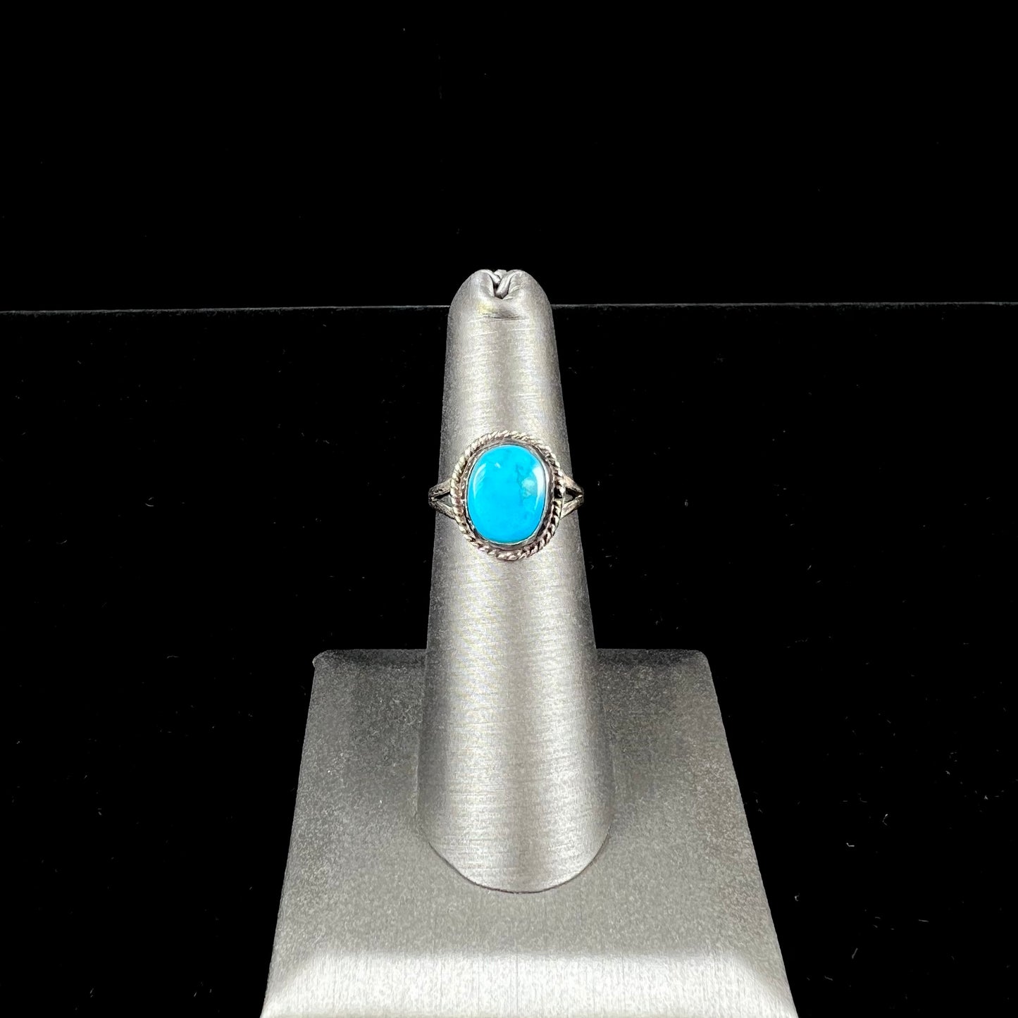 A vintage ladies' Pilot Mountain turquoise ring handmade in sterling silver with a rope accented bezel.