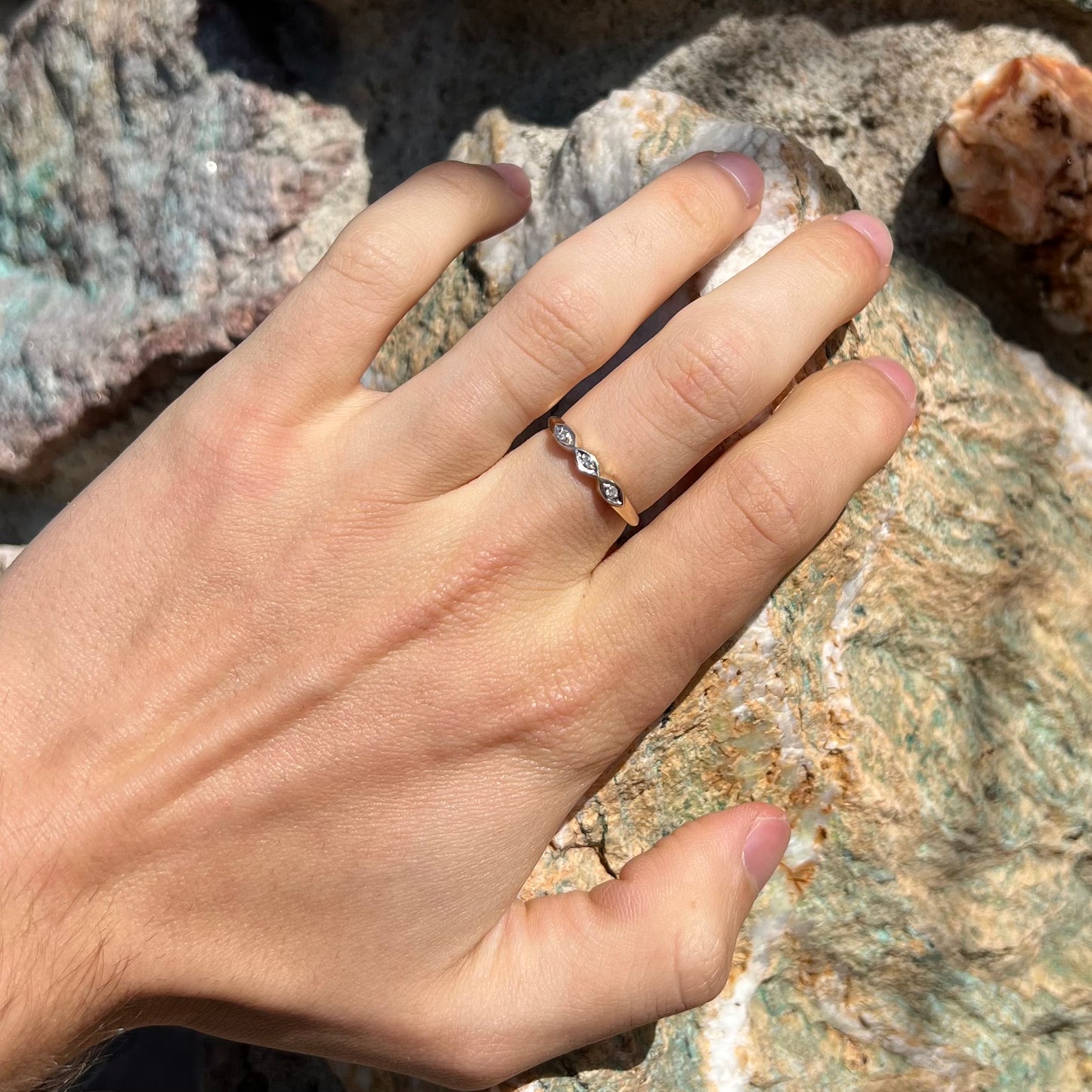 A vintage, yellow gold ladies' wedding band set with three single cut diamonds in marquise shaped designs.