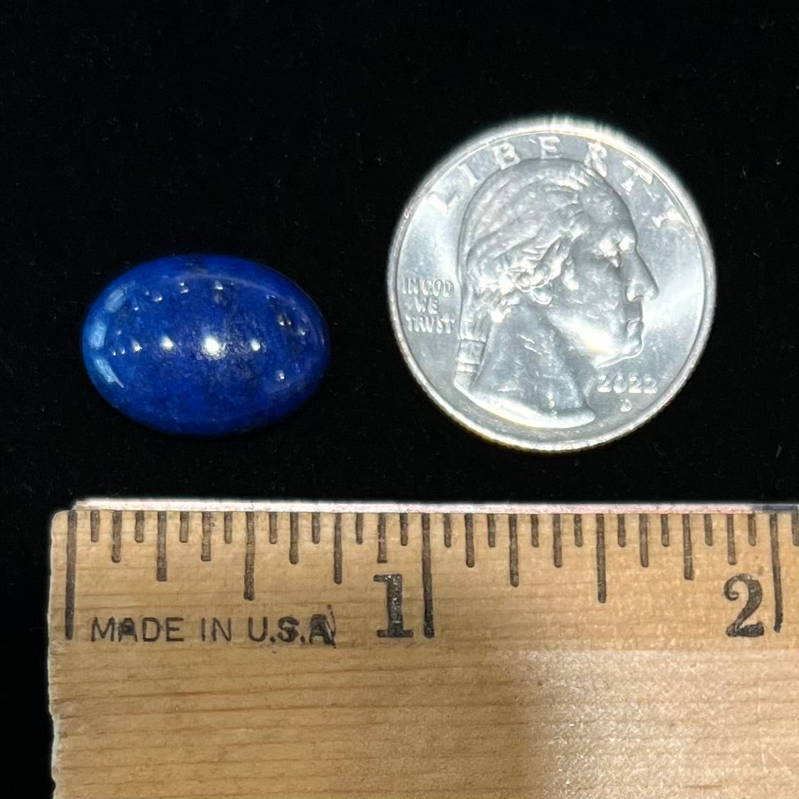 A loose, oval cabochon cut lapis lazuli stone from Blue Mountain, Afghanistan.