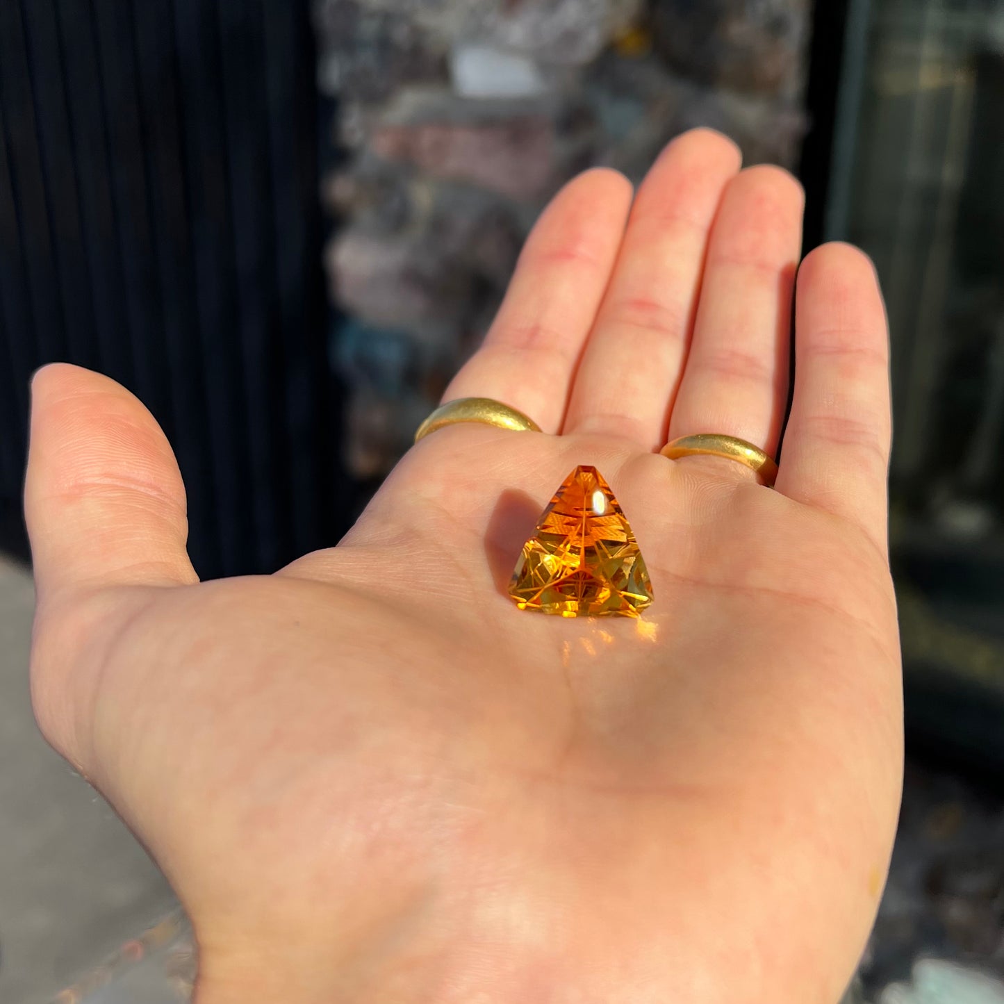 A loose, triangular fantasy cut yellow citrine stone cut by Arthur Lee Anderson.