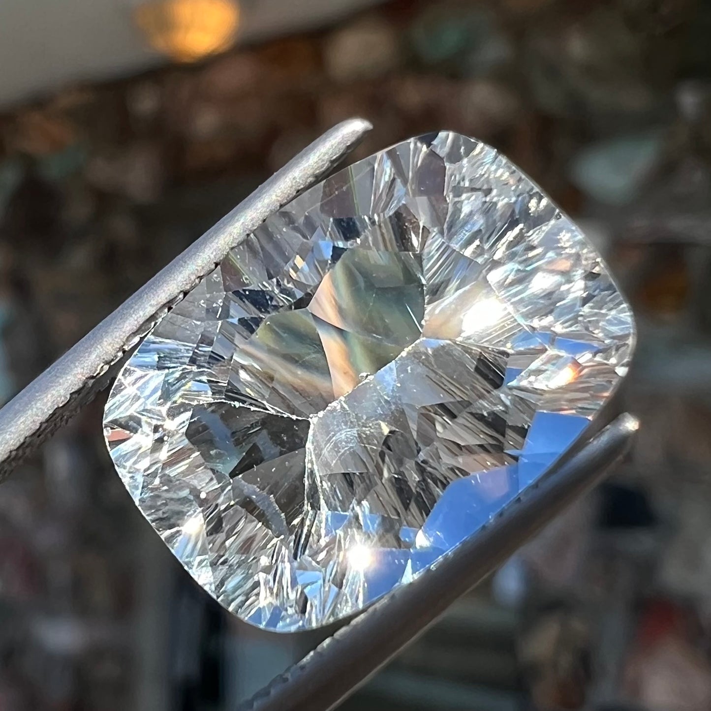 A loose, modified laser cushion cut white topaz gemstone.