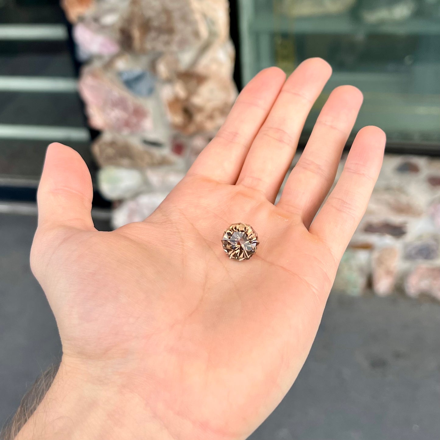 A loose, modified brilliant Portuguese cut smoky quartz gemstone.