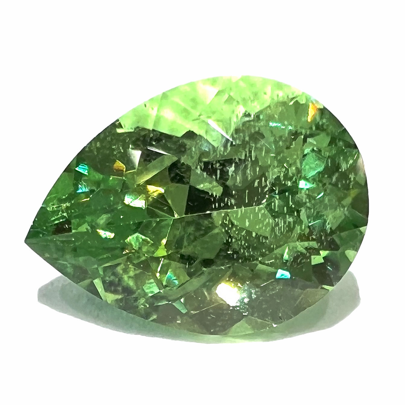 A loose, pear shaped tsavorite garnet gemstone. The stone is yellowish green and weighs 2.97 carats.