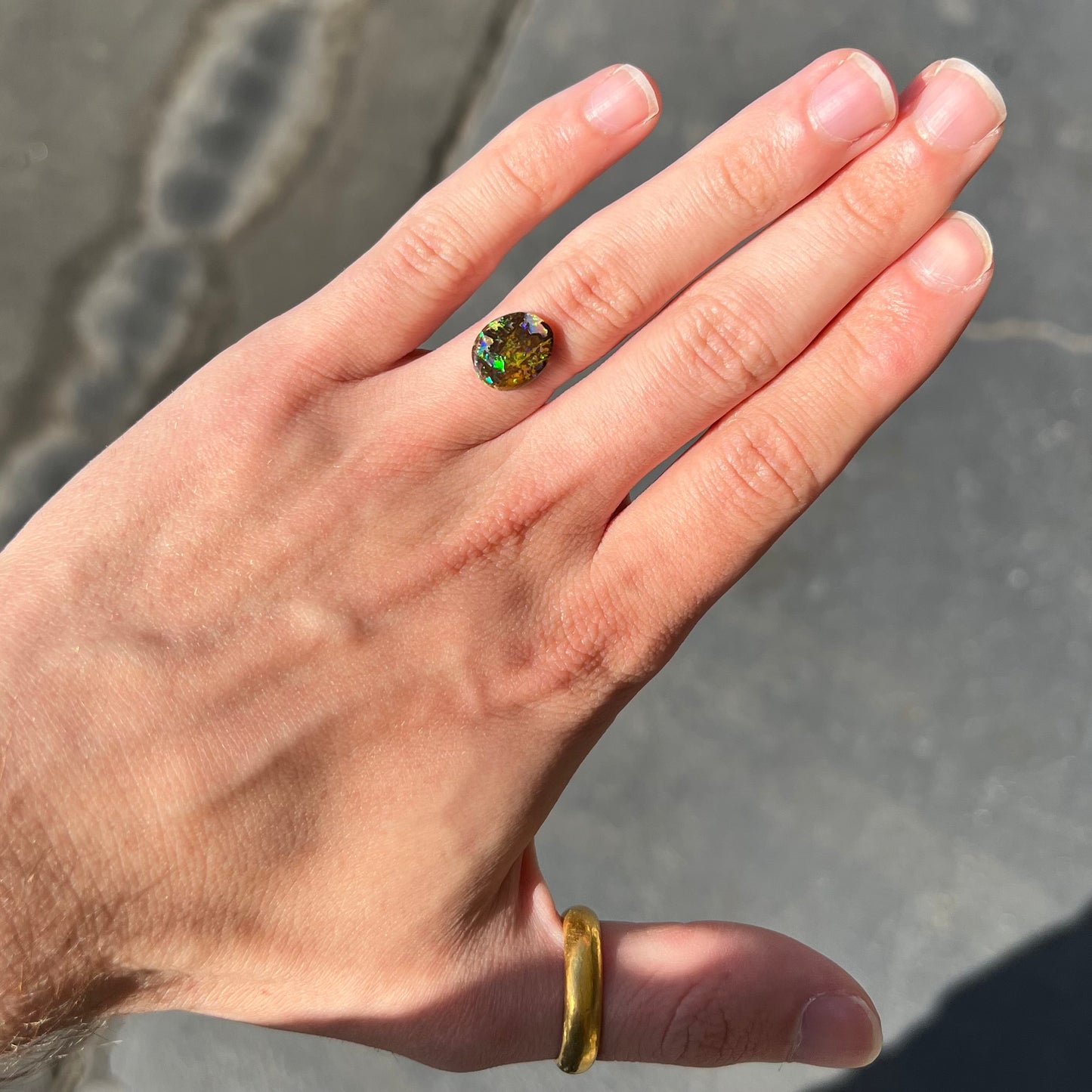 A bright green boulder opal stone from Koroit, Australia.