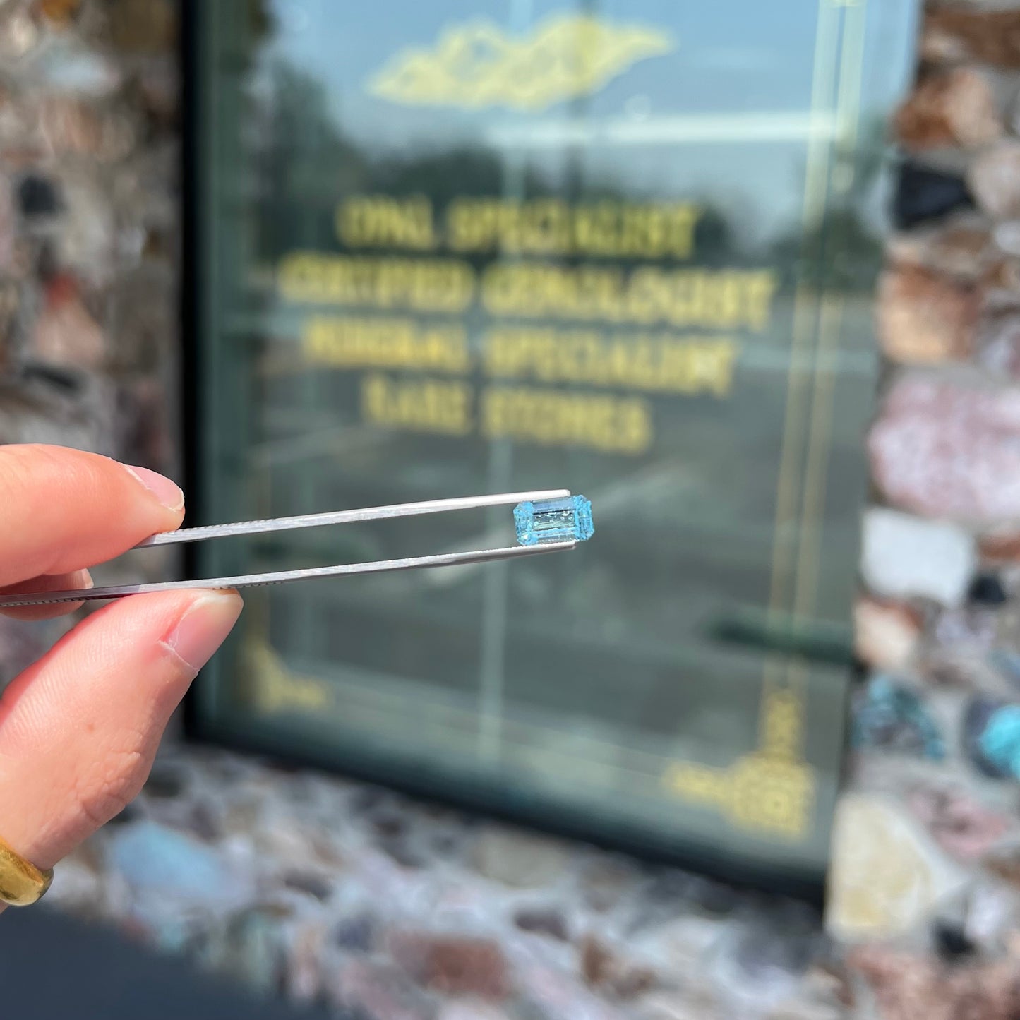 A loose, faceted emerald cut aquamarine stone. The stone is icy blue in color, indicative of Vietnamese origin.