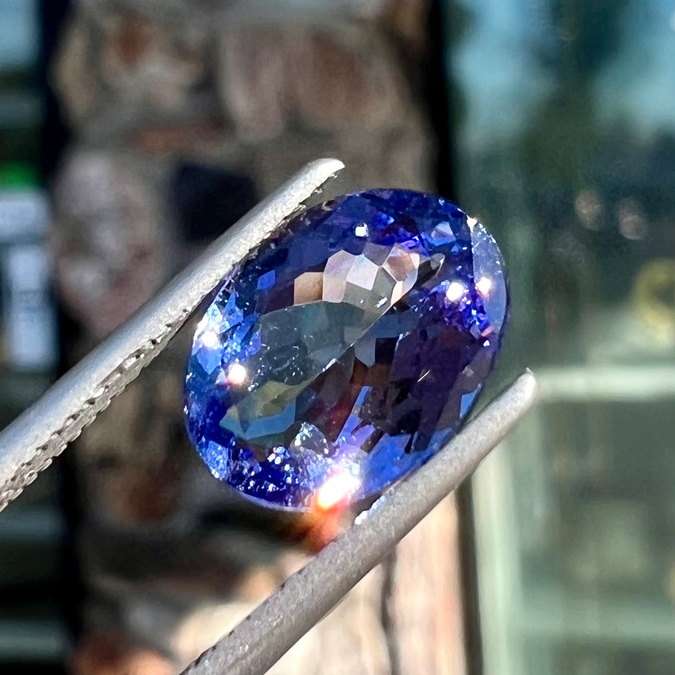 A loose, oval cut tanzanite gemstone.