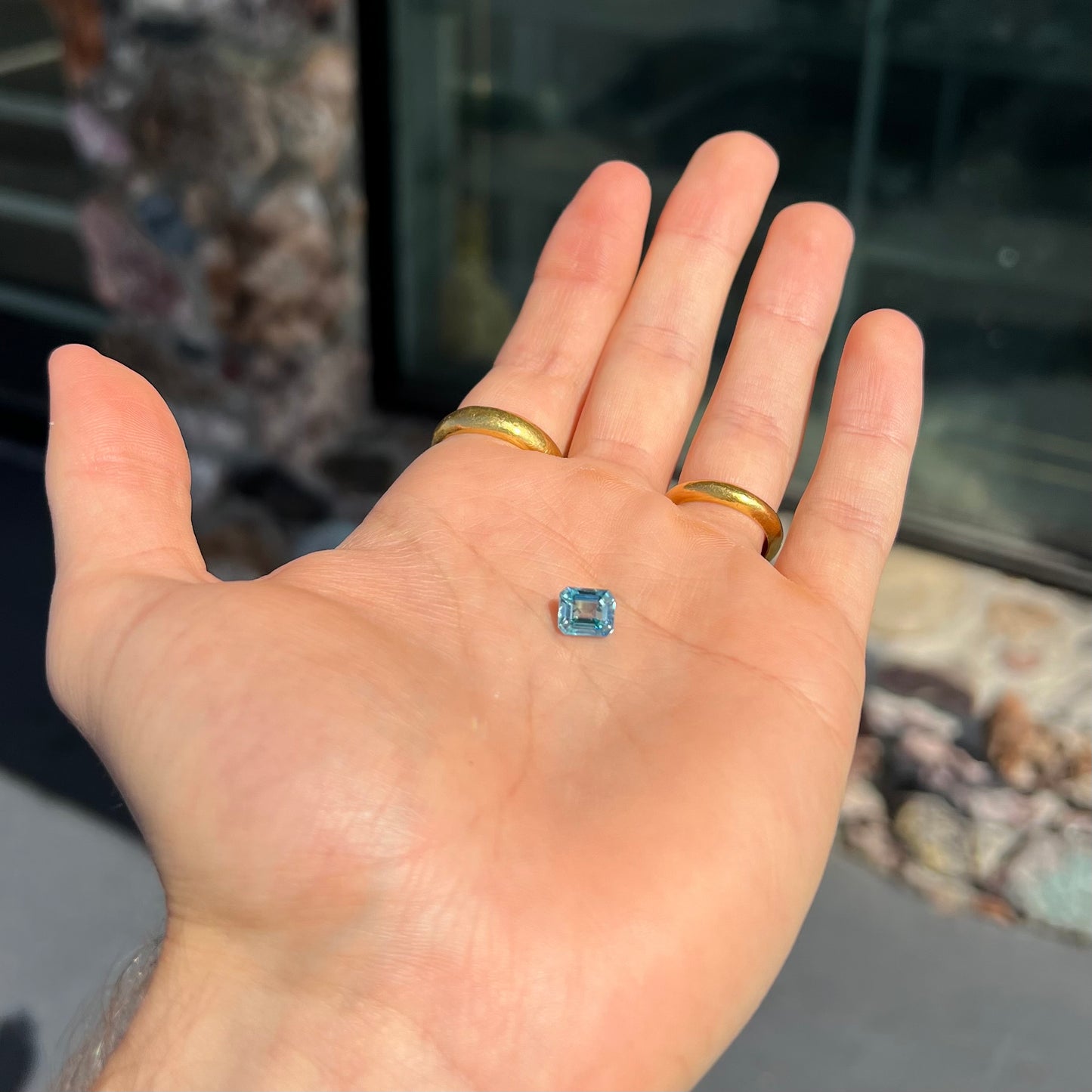 A loose, emerald cut blue zircon gemstone.