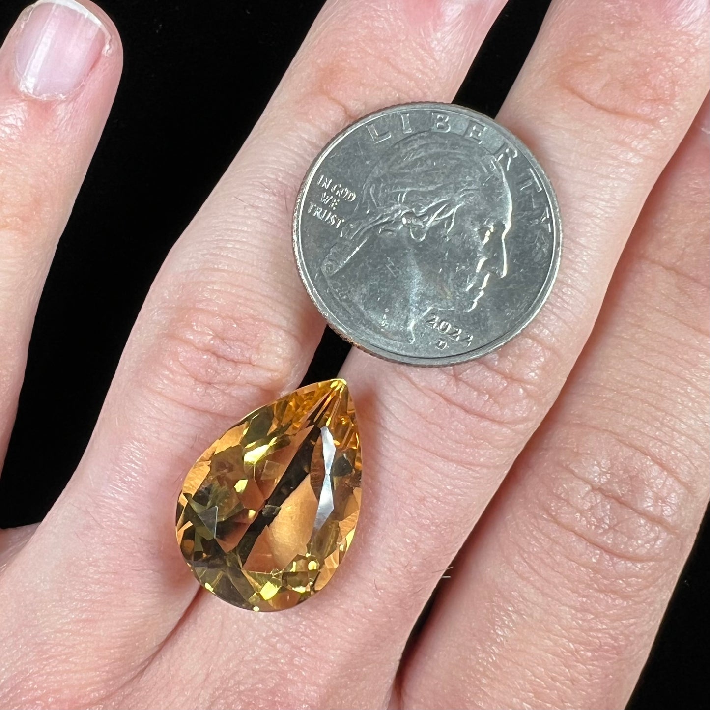 A loose, golden yellow pear shaped citrine stone.
