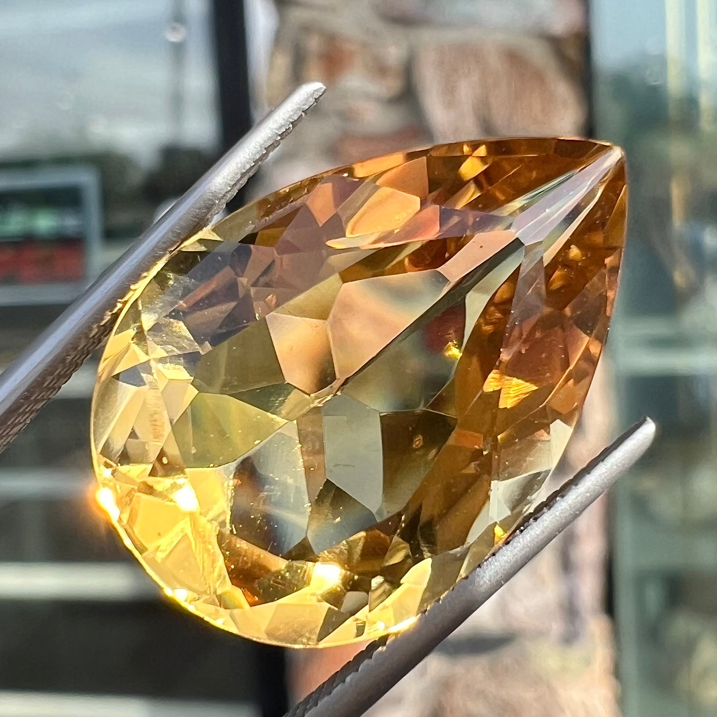 A loose, golden yellow pear shaped citrine stone.