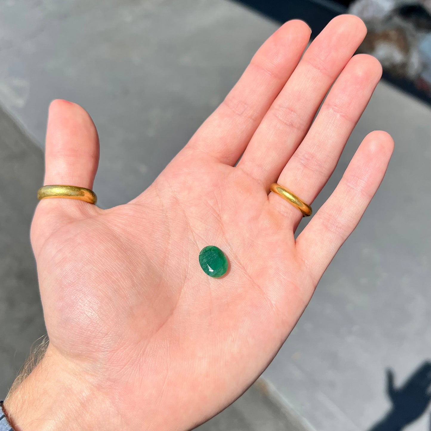 A loose, faceted oval cut commercial grade emerald stone.