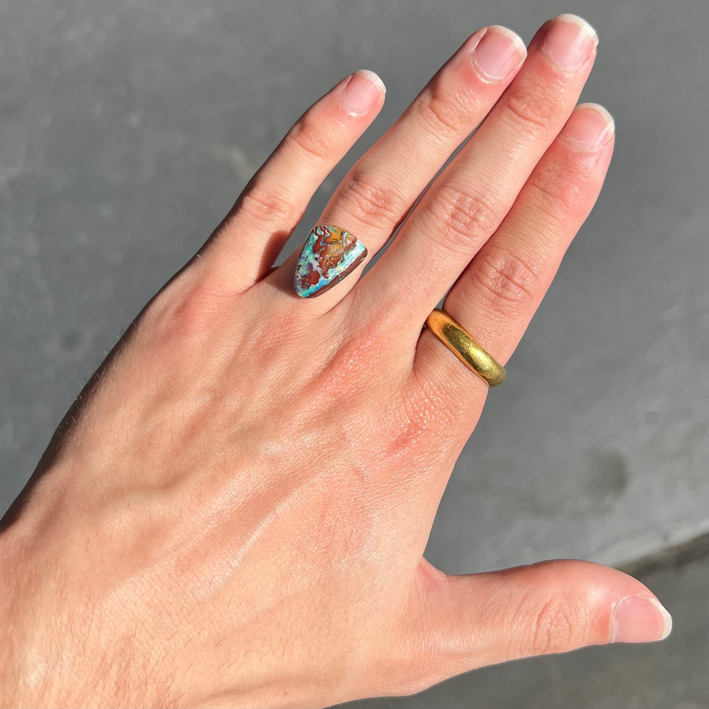 A polished matrix opal stone from Koroit, Australia. The opal has a blue color.