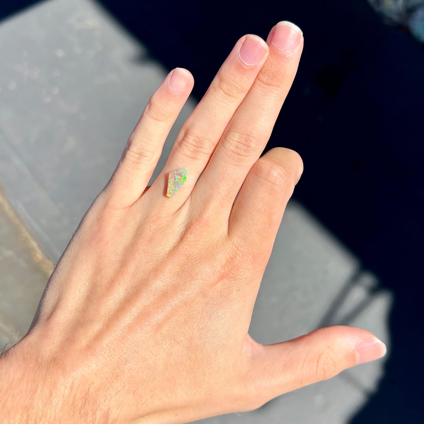 A loose, 1.27 carat Lightning Ridge crystal opal. The opal has green colors.