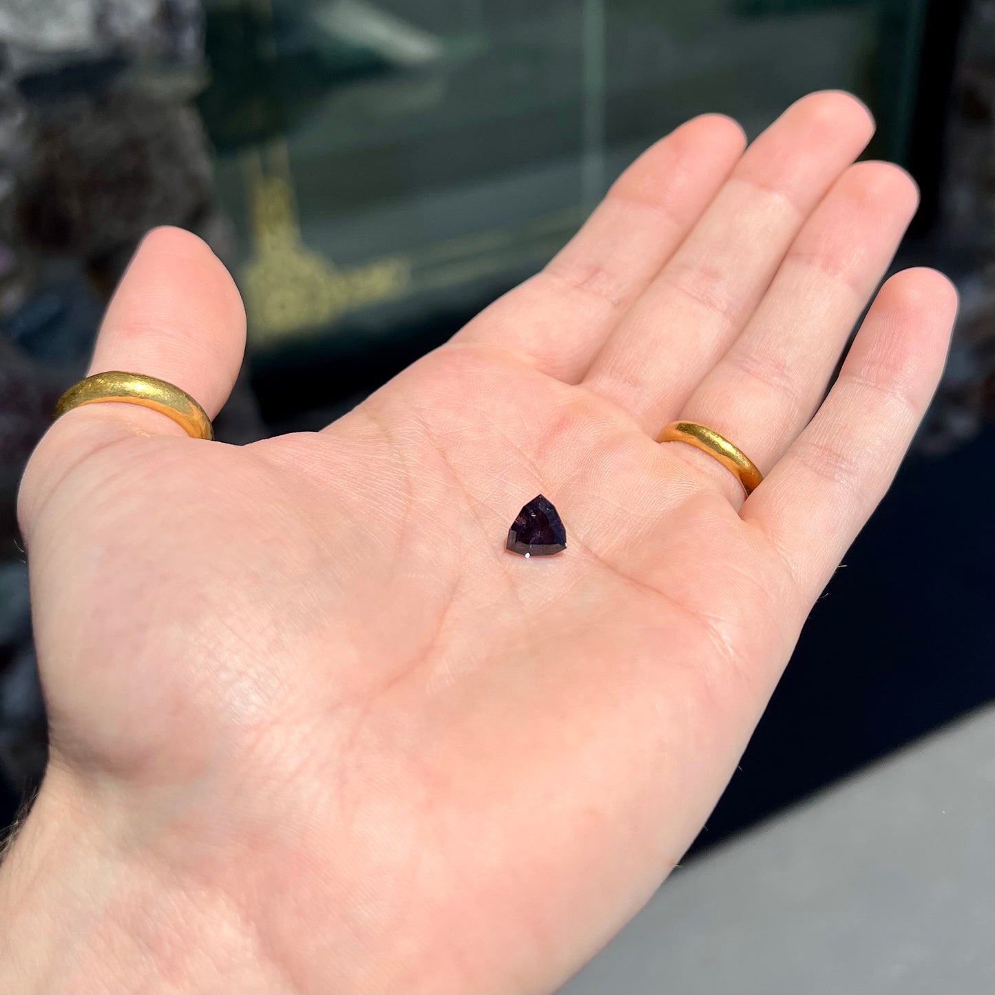 A loose, natural purple trillion cut spinel gemstone.