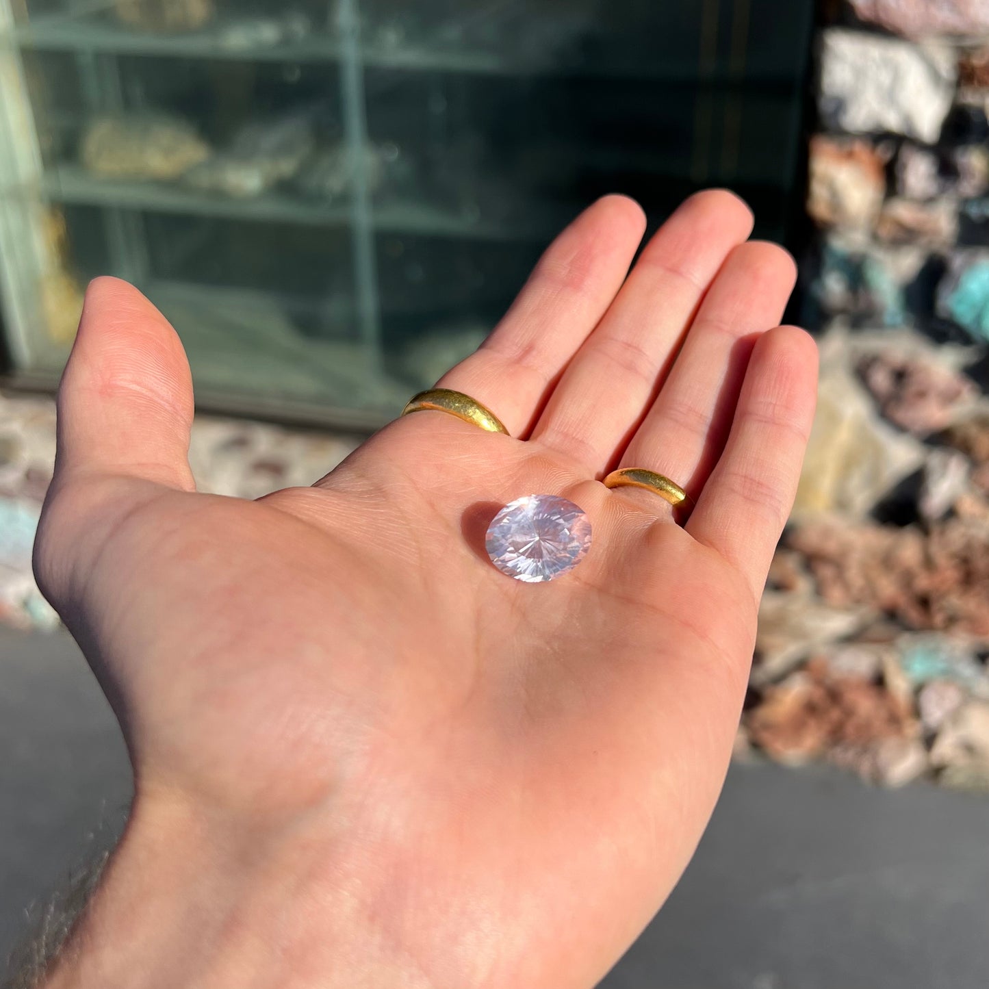 A loose, faceted oval cut rose quartz gemstone. The stone is exceptionally clear.