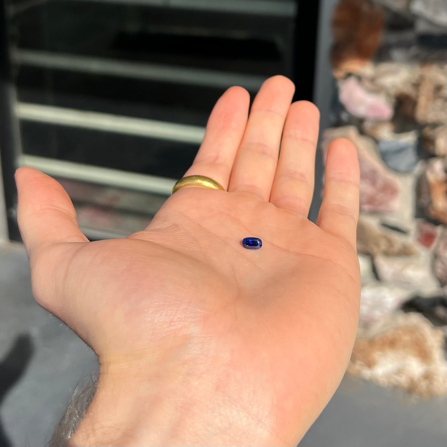 A loose, elongated oval cut blue sapphire gemstone.