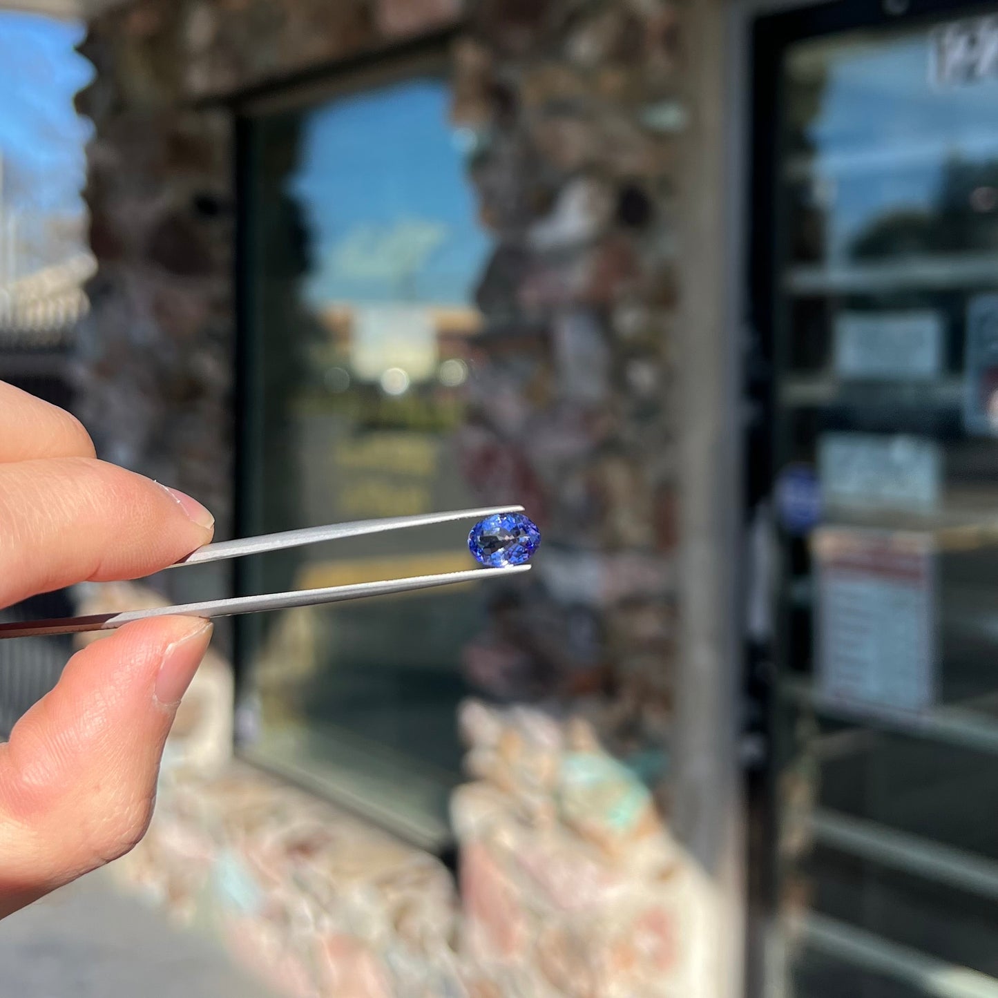 A loose, oval cut tanzanite gemstone.