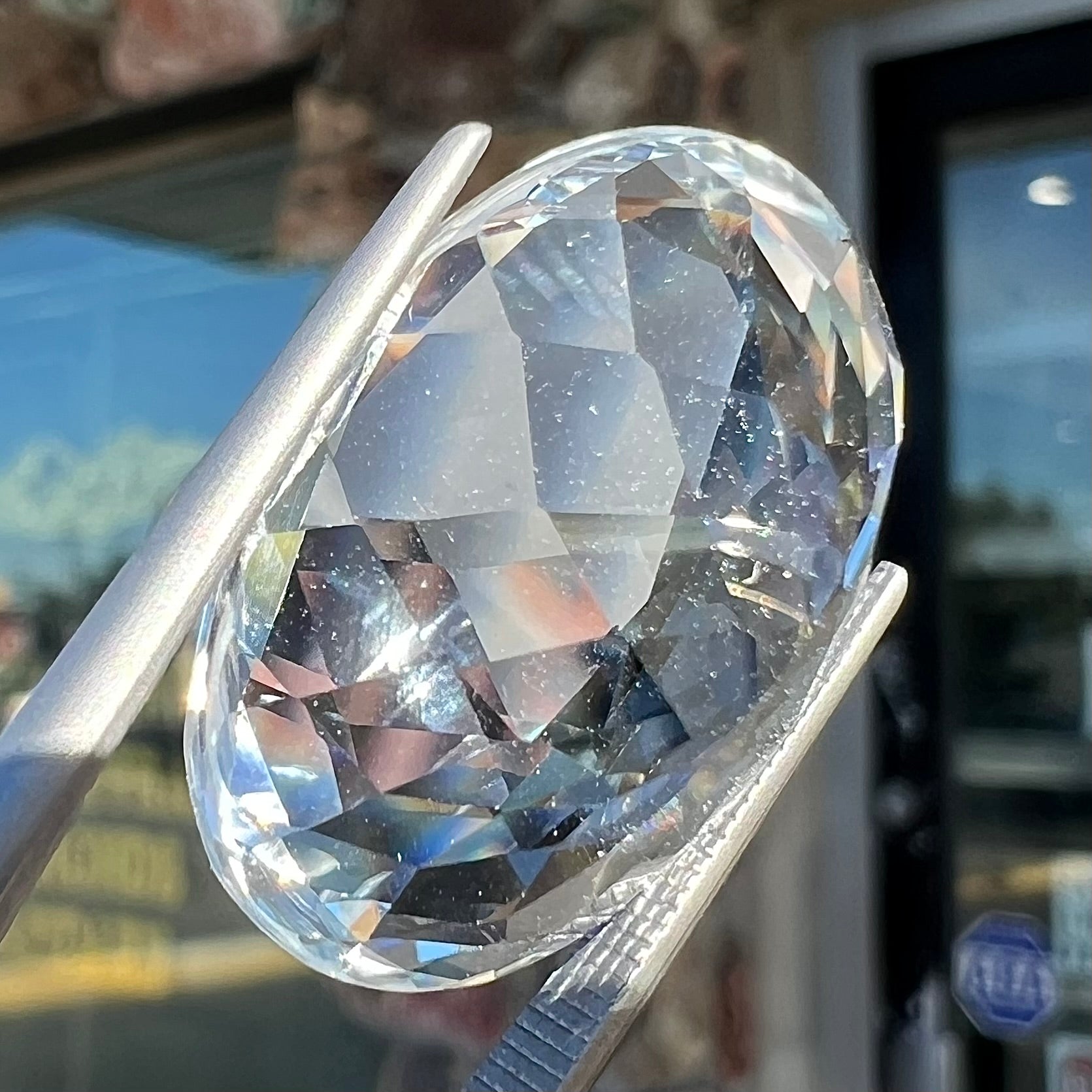 A loose, faceted oval cut white topaz gemstone.  The stone is large in size.