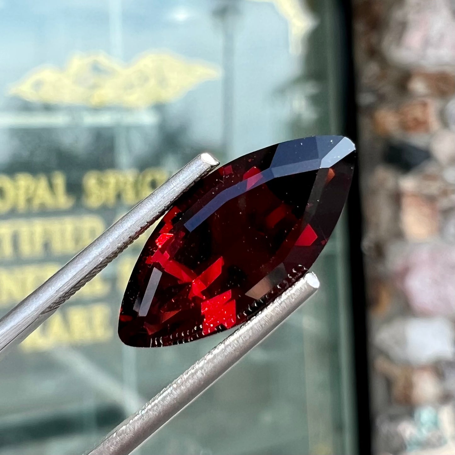 A faceted marquise cut red pyrope garnet stone.