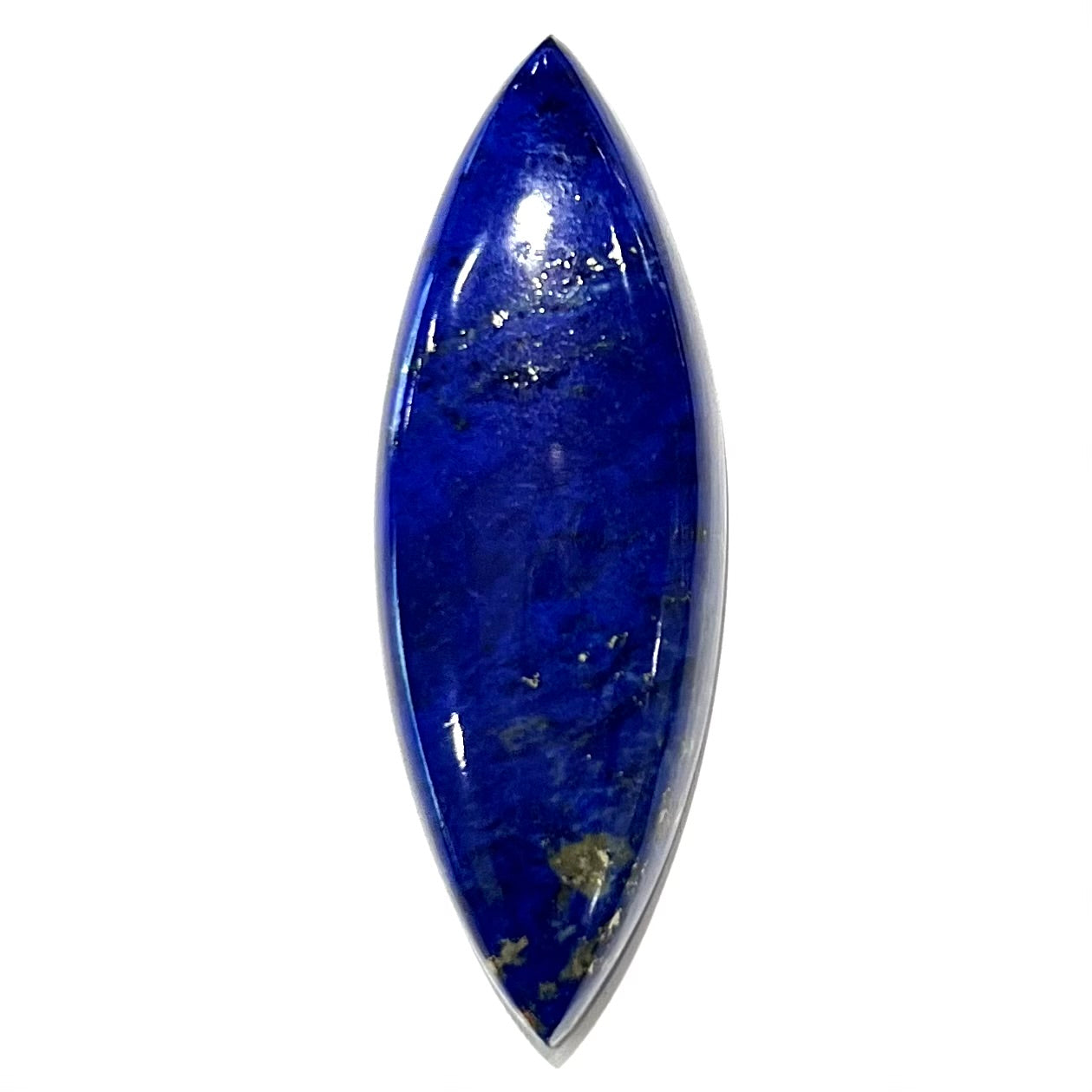 A loose, marquise cabochon cut lapis lazuli stone. The stone has pyrite inclusions.