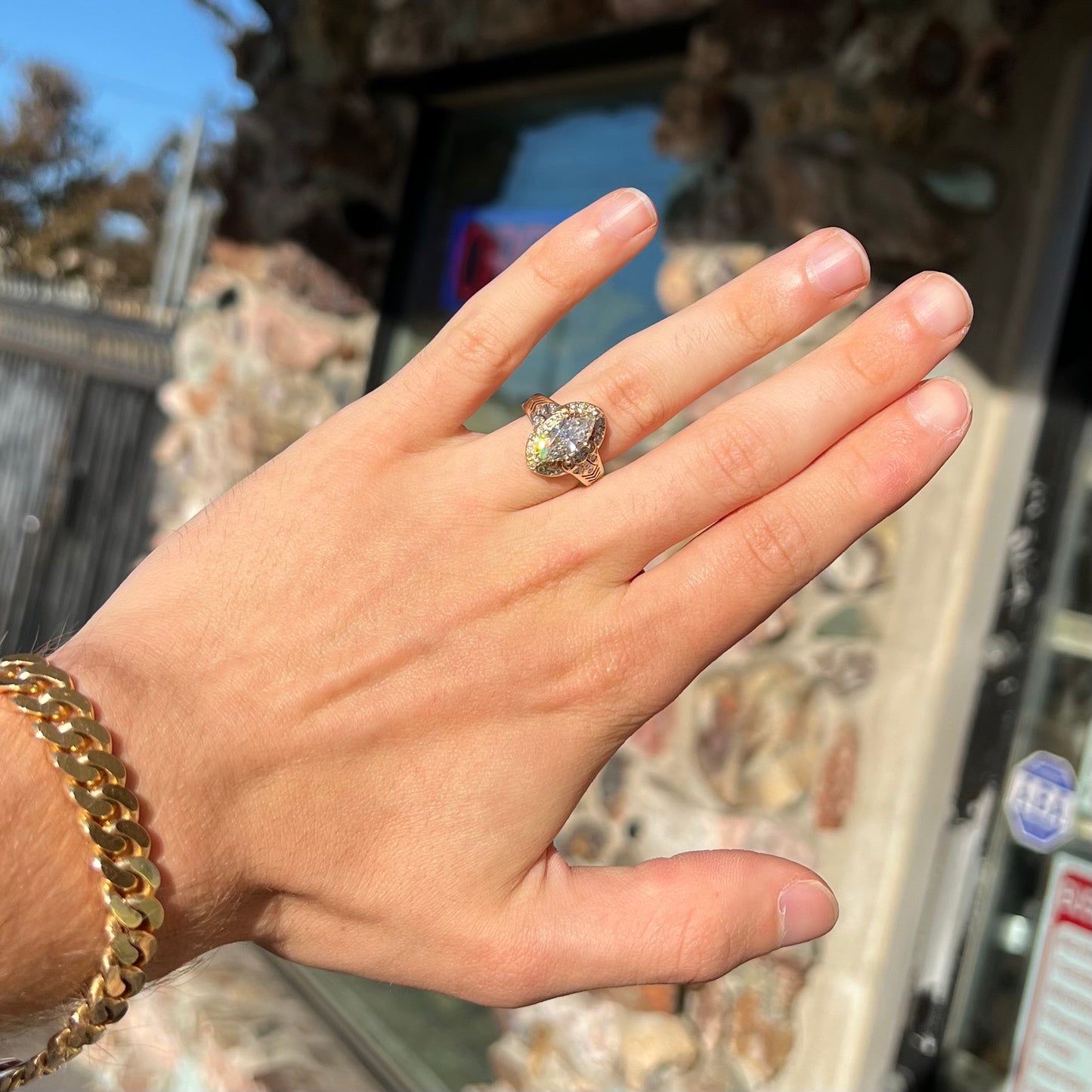 A ladies' yellow gold engagement ring set with a 1.54ct marquise cut natural diamond with round diamond accents.