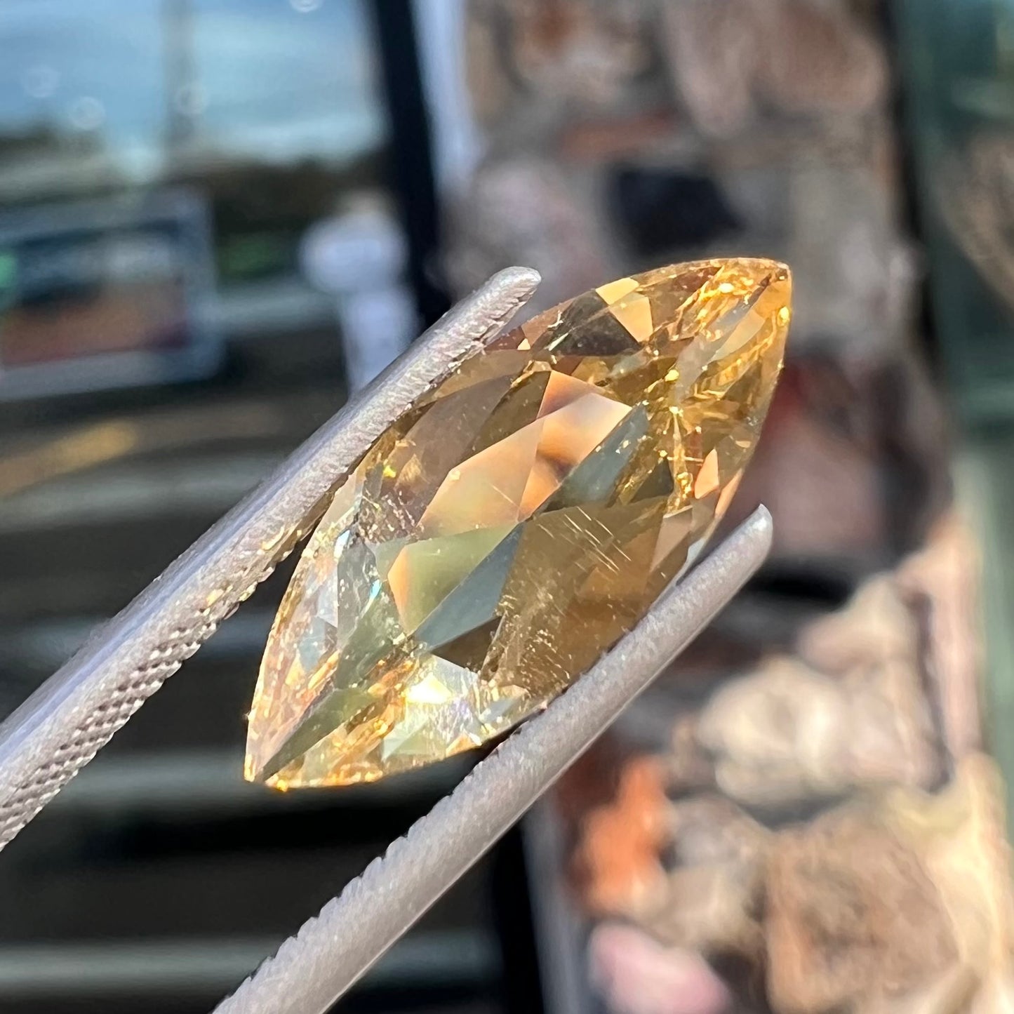 A loose, marquise cut golden beryl gemstone. The stone is a light yellow color.